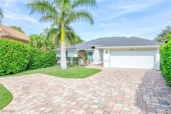 a front view of a house with a garden