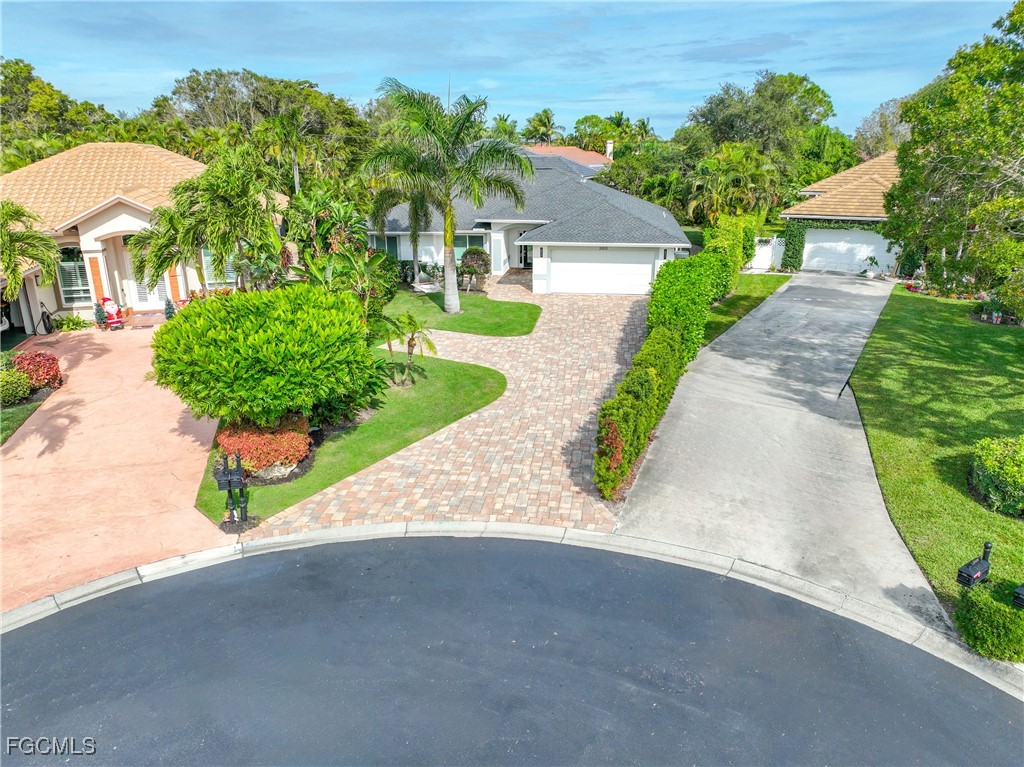 2003 Timberline Drive Naples, FL 34109 - Photo 11 of 44 a view of a garden with a patio