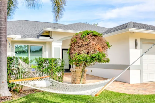 a view of a house with a porch and a swimming pool