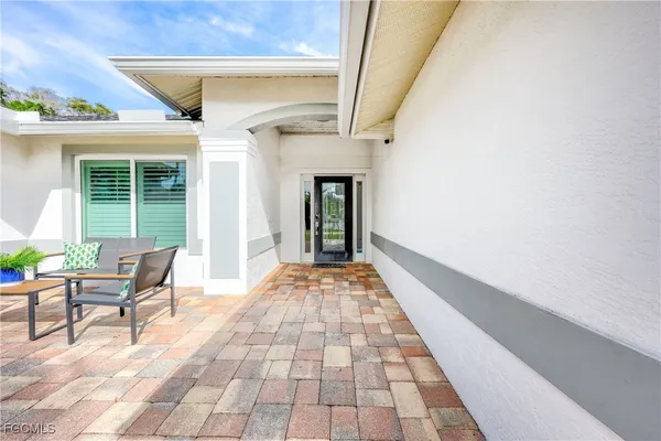 a view of a patio with table and chairs