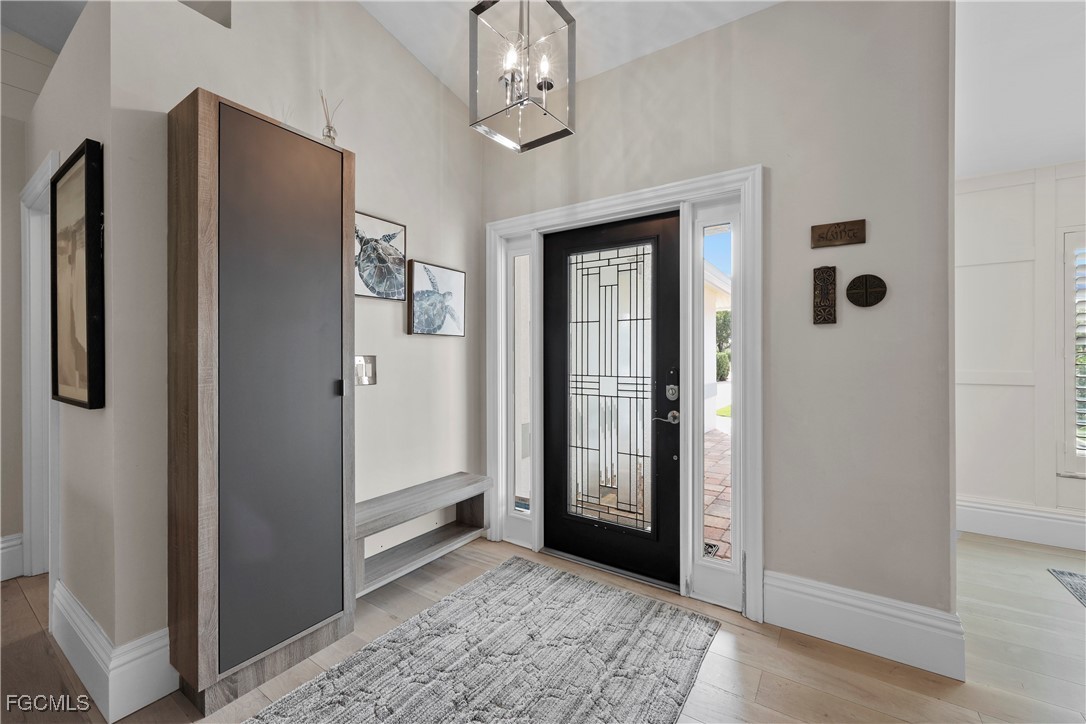 2003 Timberline Drive Naples, FL 34109 - Photo 16 of 44 wooden floor and windows in an empty room
