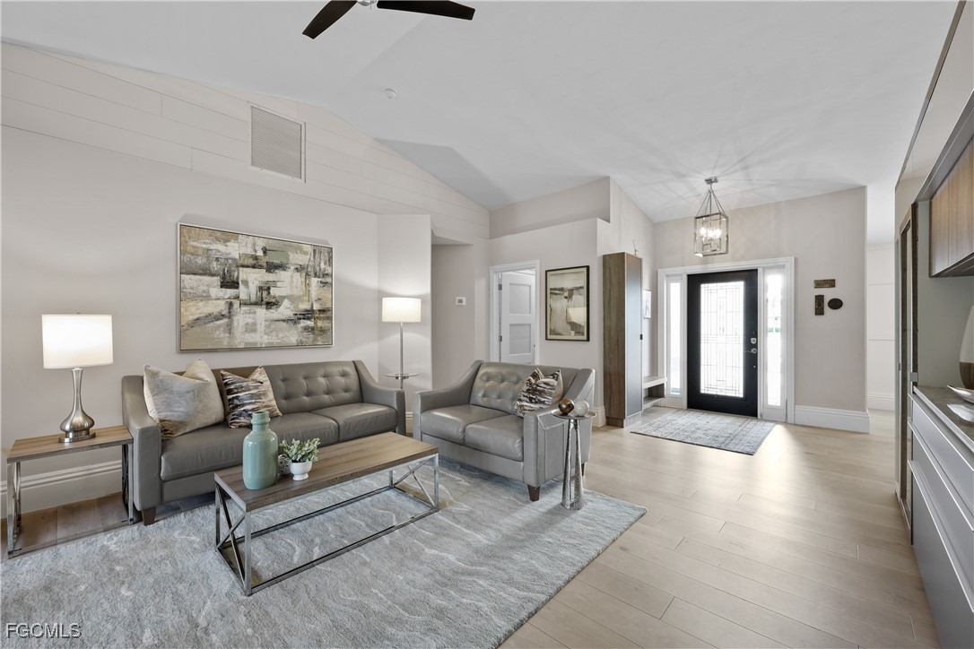 2003 Timberline Drive Naples, FL 34109 - Photo 22 of 44 a living room with furniture and a chandelier