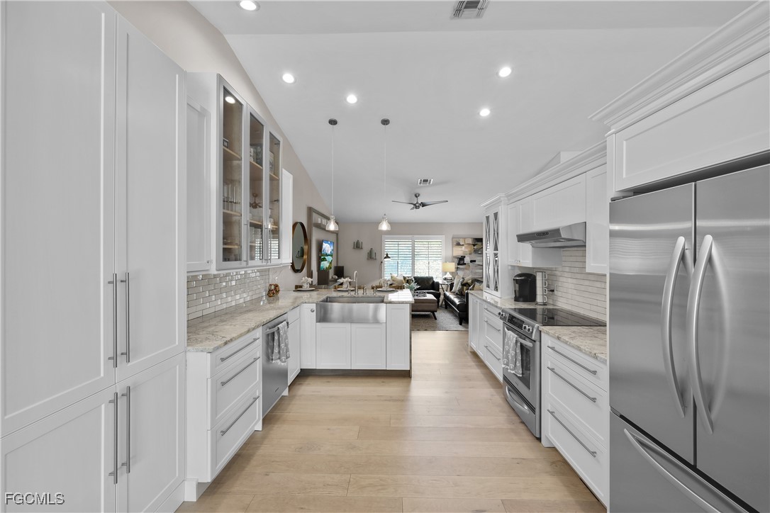 2003 Timberline Drive Naples, FL 34109 - Photo 25 of 44 a large kitchen with stainless steel appliances lots of white cabinets