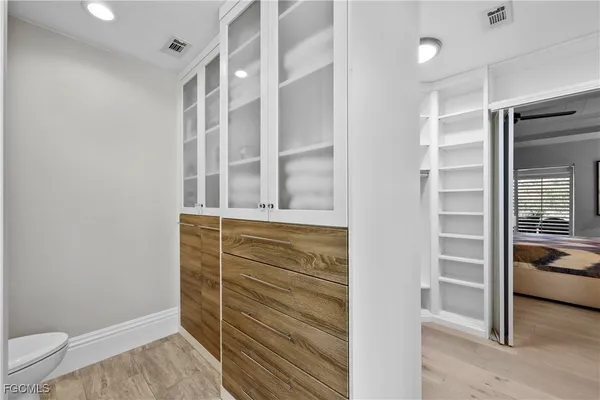 a view of walk in closet with clothes and shoes