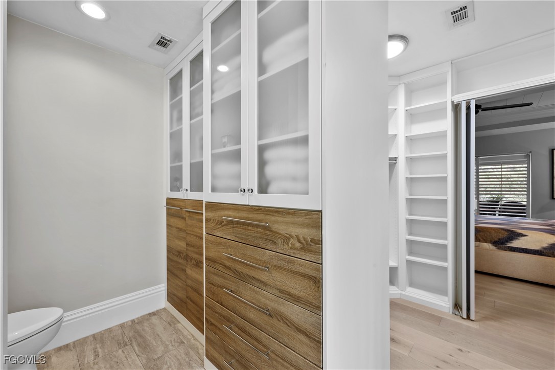 2003 Timberline Drive Naples, FL 34109 - Photo 29 of 44 a view of walk in closet with clothes and shoes