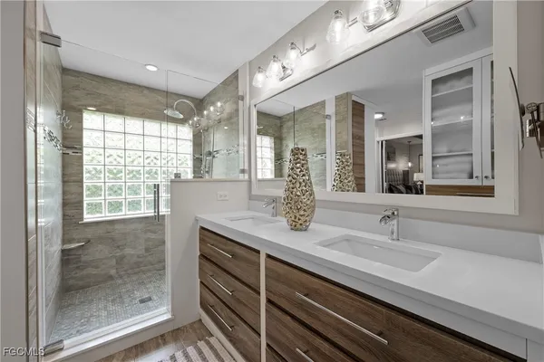 a bathroom with a granite countertop sink mirror and double