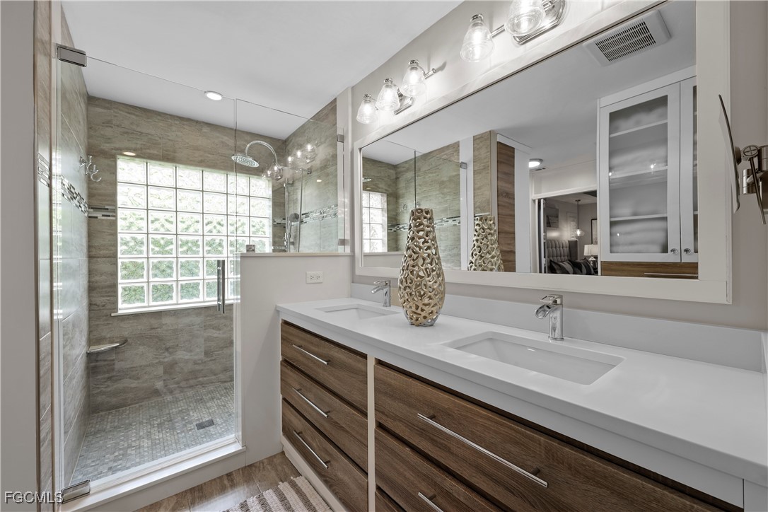2003 Timberline Drive Naples, FL 34109 - Photo 30 of 44 a bathroom with a granite countertop sink mirror and double