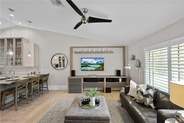 a living room with furniture a window and a clock