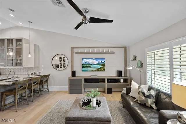 a living room with furniture a window and a clock