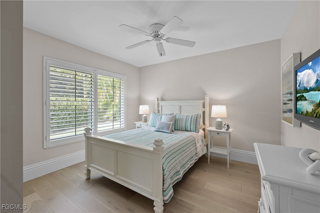 2003 Timberline Drive Naples, FL 34109 - Photo 33 of 44 a bedroom with a bed and a chandelier