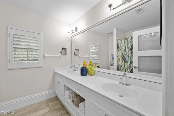 a bathroom with a sink and a window