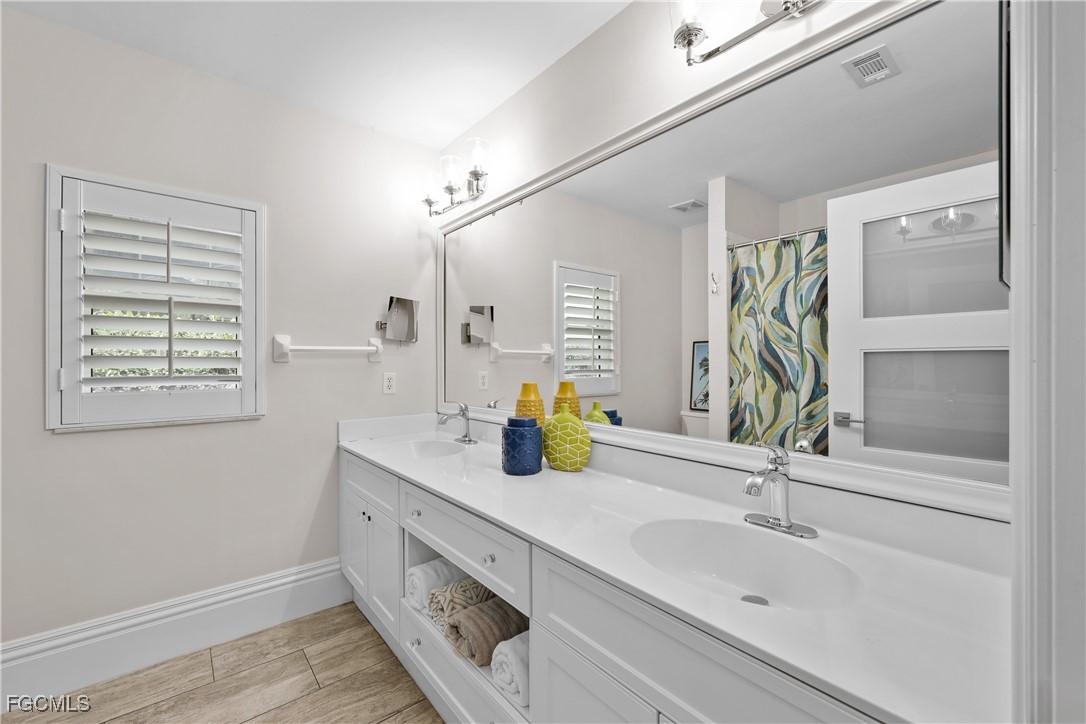 2003 Timberline Drive Naples, FL 34109 - Photo 34 of 44 a bathroom with a sink and a window