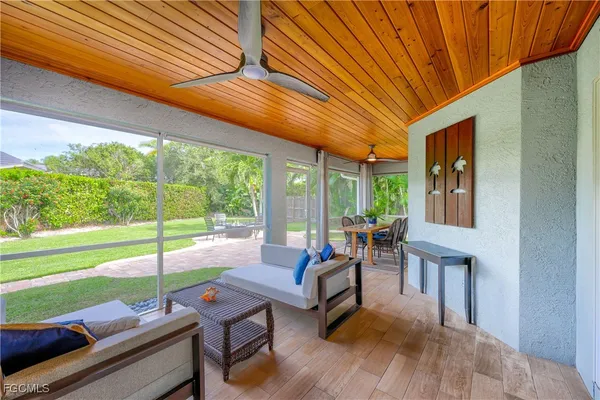 a outdoor space with patio the couches and pool table with chairs and floor to ceiling window with yard