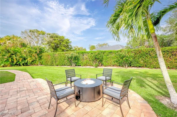 a view of a chairs and table in the garden