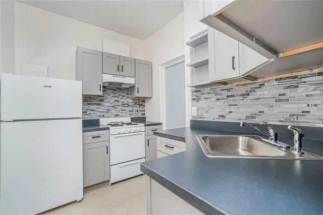 a kitchen with a refrigerator sink and stove