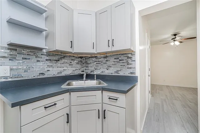 a kitchen with a sink and cabinets