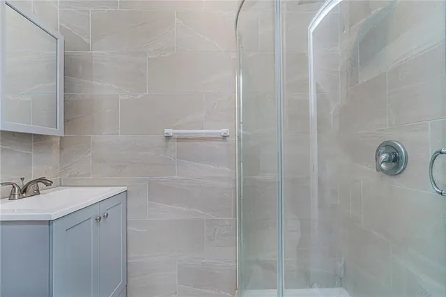 a bathroom with a shower and sink