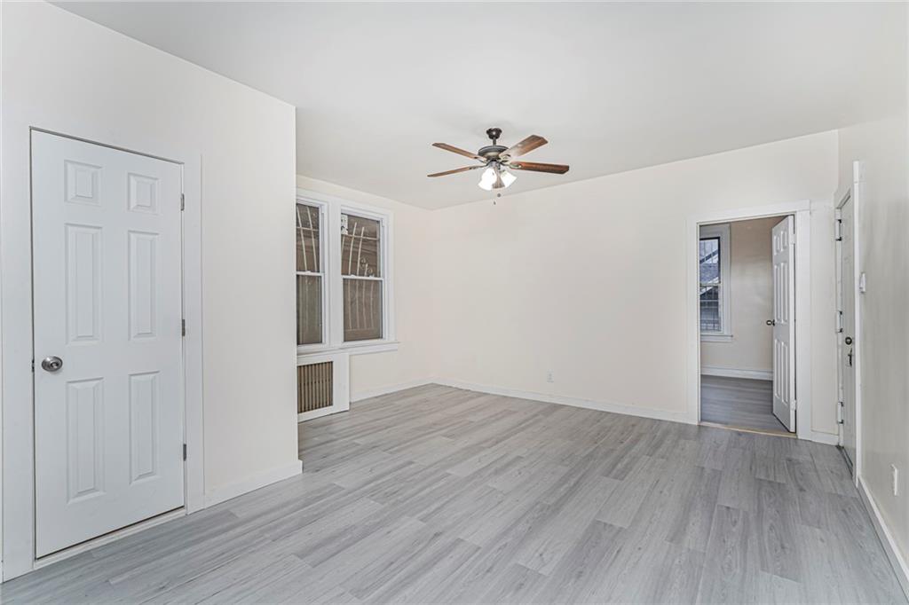 217 Brighton 1st Lane Brooklyn, NY 11235 - Photo 7 of 24 wooden floor in an empty room with a window