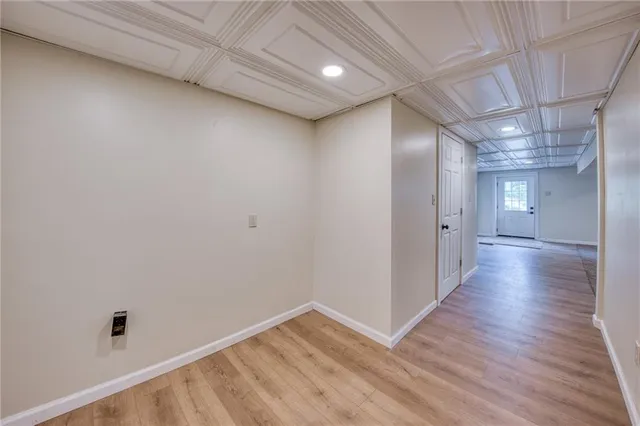 a view of a hallway with wooden floor