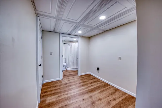 a view of hallway with wooden floor
