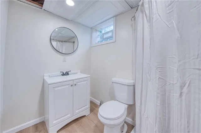 a bathroom with a toilet a sink and a mirror