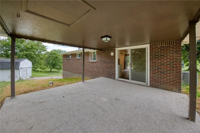 a view of a house with backyard and a garage