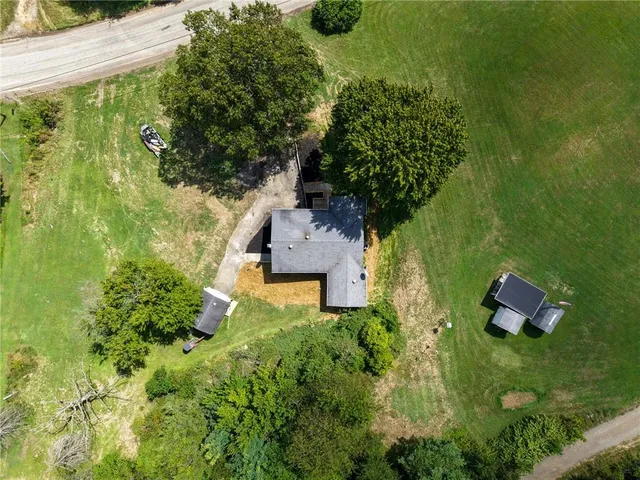 an aerial view of a house with a yard