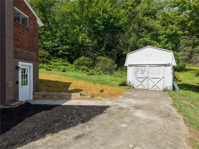 an aerial view of a house with pool and yard