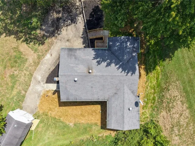 an aerial view of a residential houses with outdoor space and street view