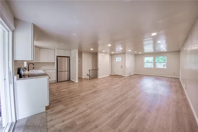 a view of a kitchen with a sink and a refrigerator
