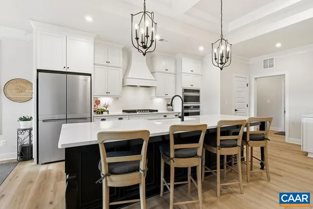 a kitchen with stainless steel appliances white cabinets and a stove