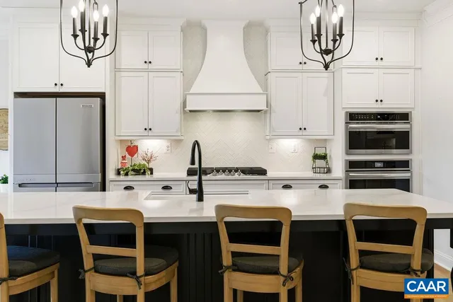 a kitchen with stainless steel appliances a sink stove and cabinets