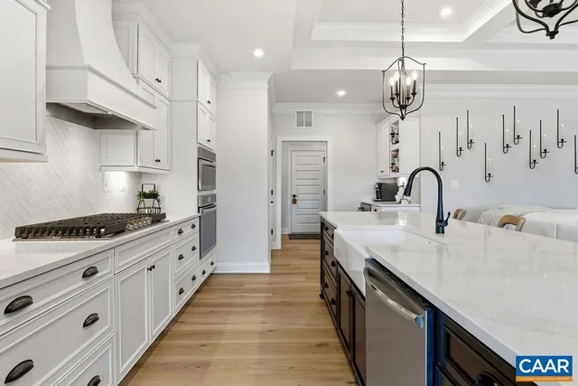a kitchen with white cabinets and appliances