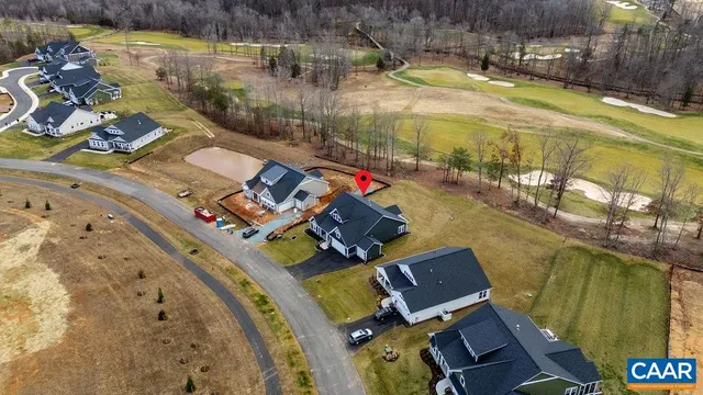 an aerial view of a house with a swimming pool