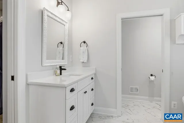 a bathroom with a sink and two mirror