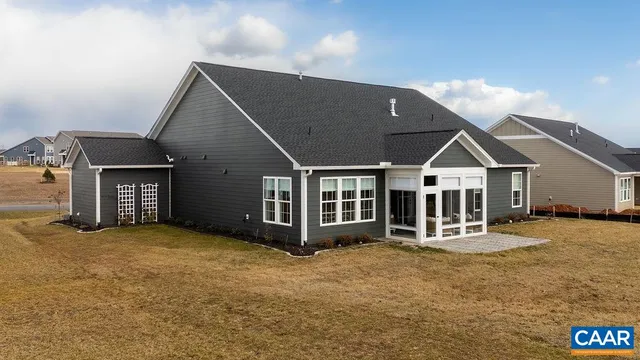 a view of a house with large yard and porch