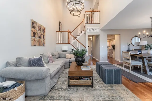 a living room with furniture and a chandelier