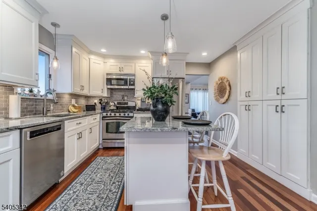 a kitchen with kitchen island granite countertop lots of counter top space and appliances