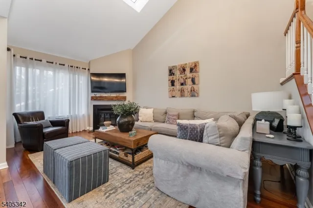 a living room with furniture fireplace and a window