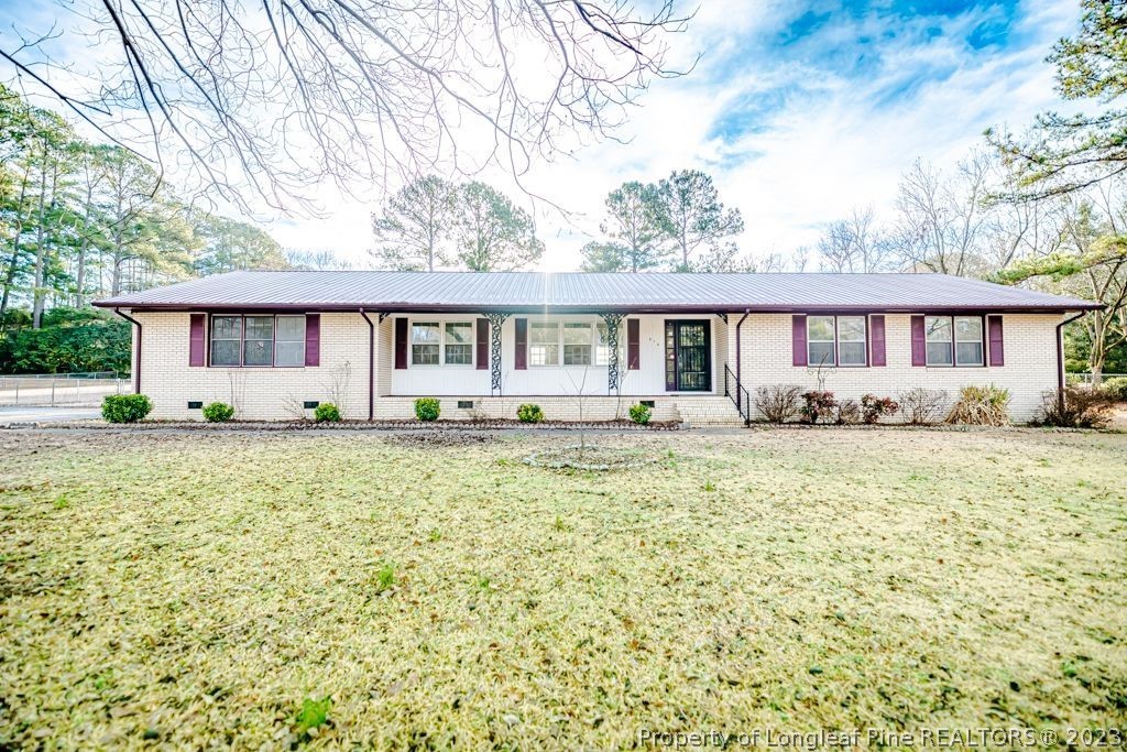 634 Richmond Road Rockingham, NC 28379 - Photo 1 of 40 a front view of a house with a garden and yard