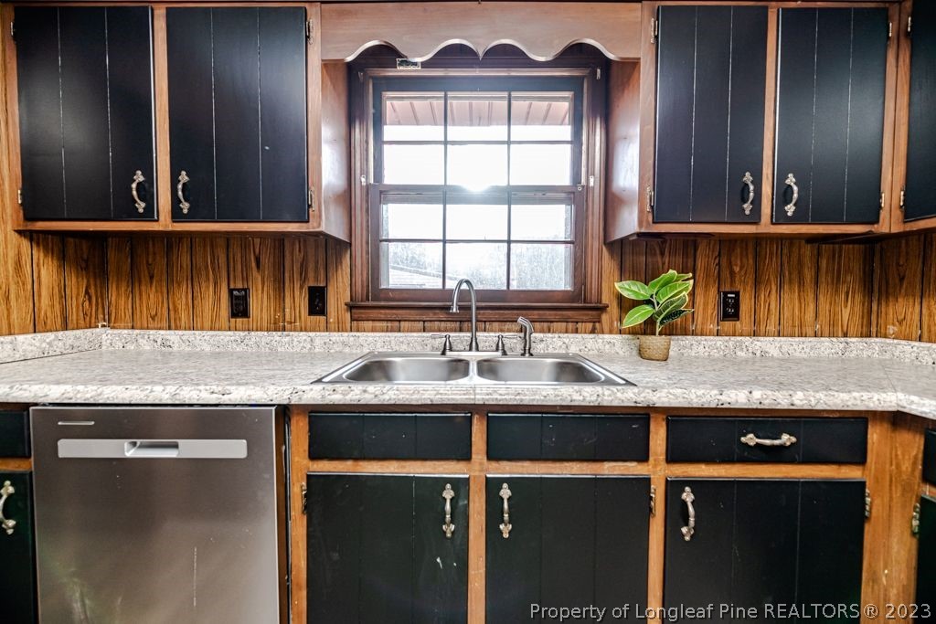 634 Richmond Road Rockingham, NC 28379 - Photo 12 of 40 a kitchen with granite countertop a sink and a window