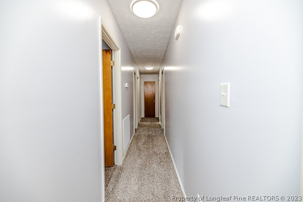 634 Richmond Road Rockingham, NC 28379 - Photo 14 of 40 a view of a hallway with wooden floor