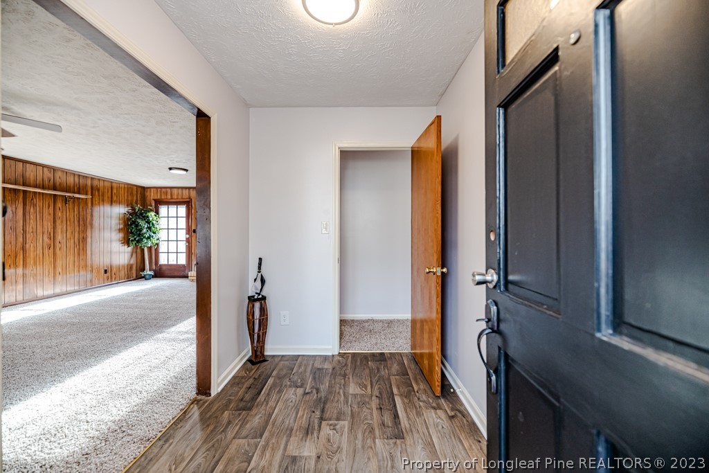 634 Richmond Road Rockingham, NC 28379 - Photo 2 of 40 a view of a hallway with wooden floor and staircase