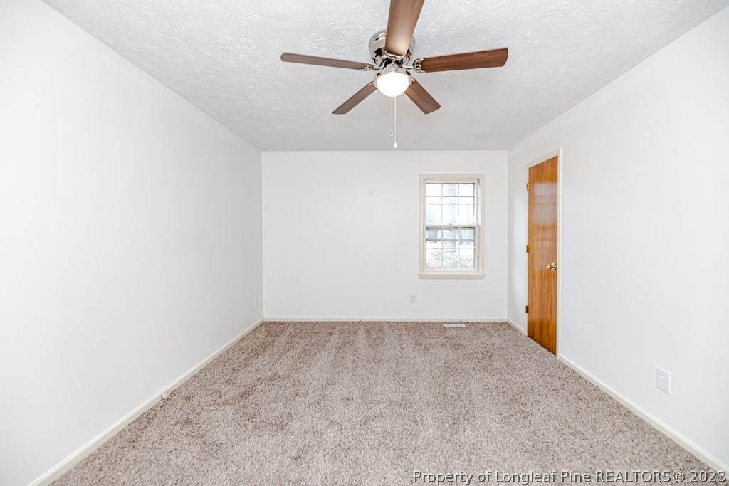 634 Richmond Road Rockingham, NC 28379 - Photo 22 of 40 an empty room with windows and fan
