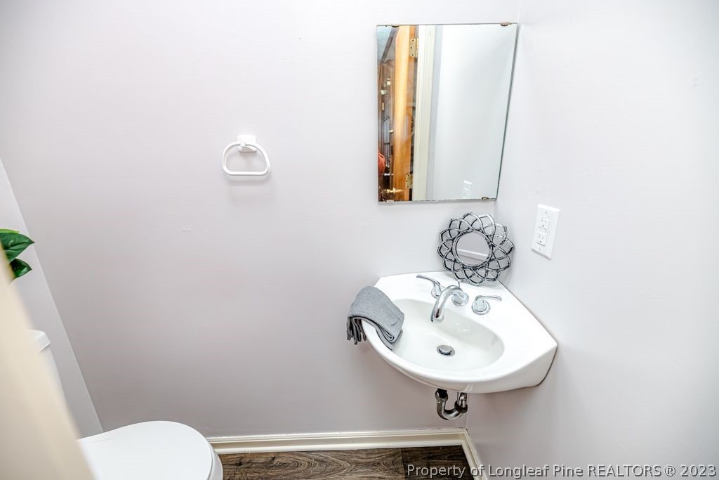 634 Richmond Road Rockingham, NC 28379 - Photo 32 of 40 a bathroom with a sink a toilet and mirror