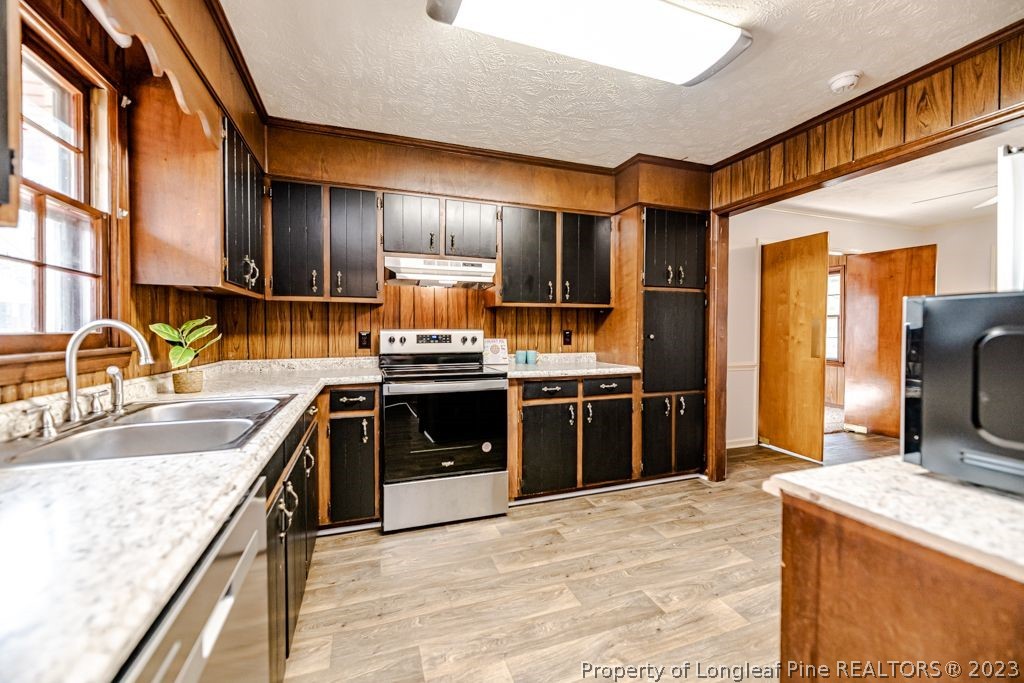 634 Richmond Road Rockingham, NC 28379 - Photo 7 of 40 a kitchen with stainless steel appliances granite countertop a sink and a stove