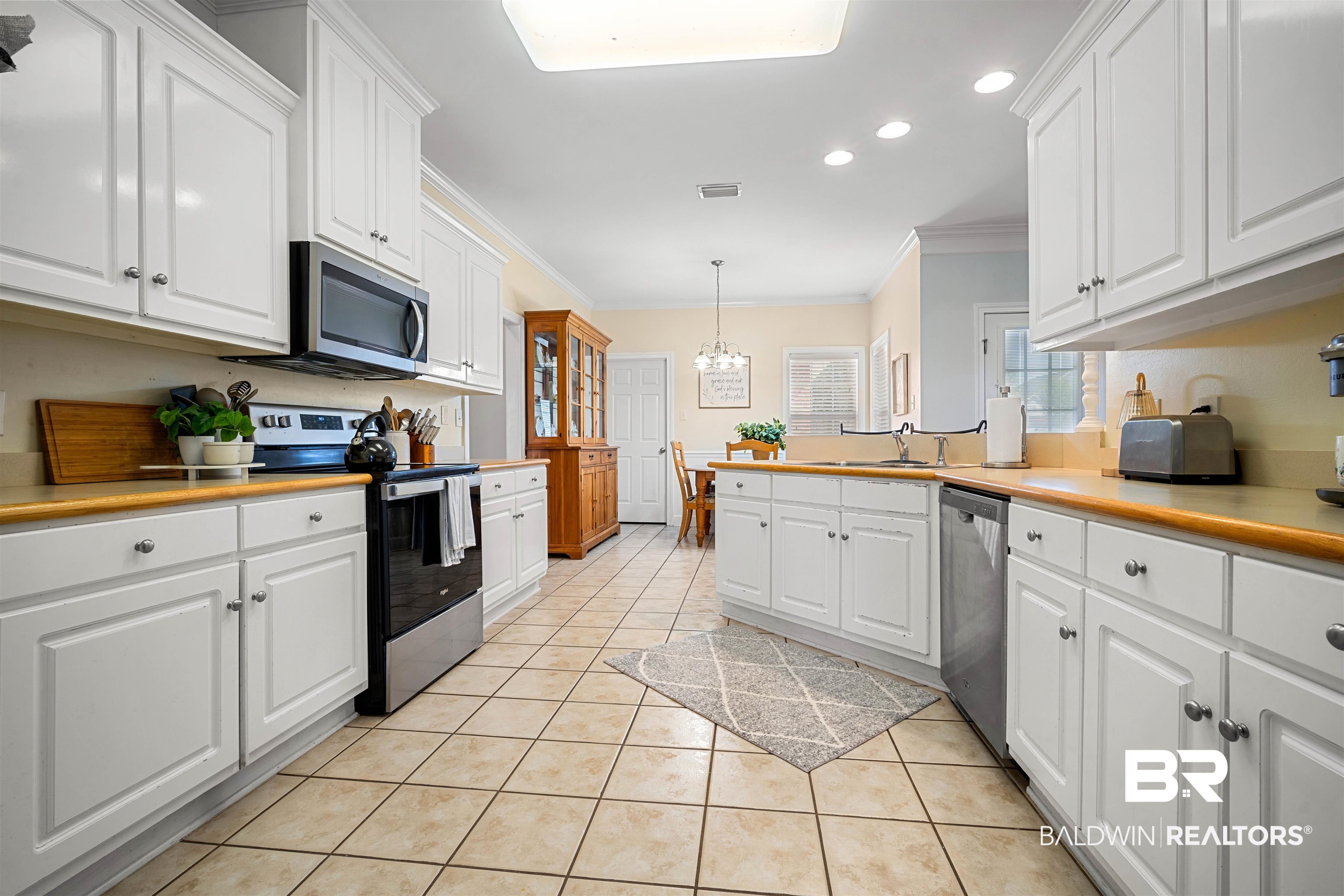 9552 White Castle Road Mobile, AL 36695 - Photo 8 of 31 Kitchen with crown molding, stainless steel appliances, white cabinetry, and recessed lighting