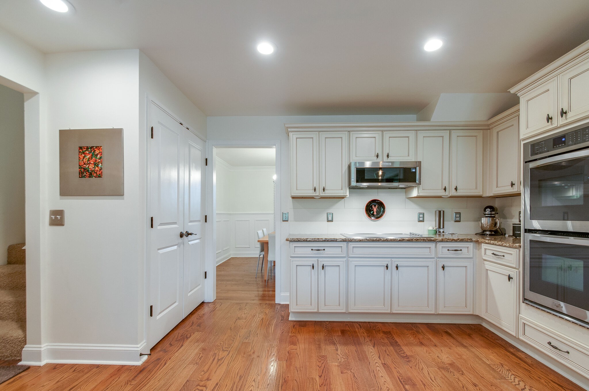147 Baltusrol Road Franklin, TN 37069 - Photo 23 of 41 a kitchen with stainless steel appliances granite countertop a stove a sink and white cabinets