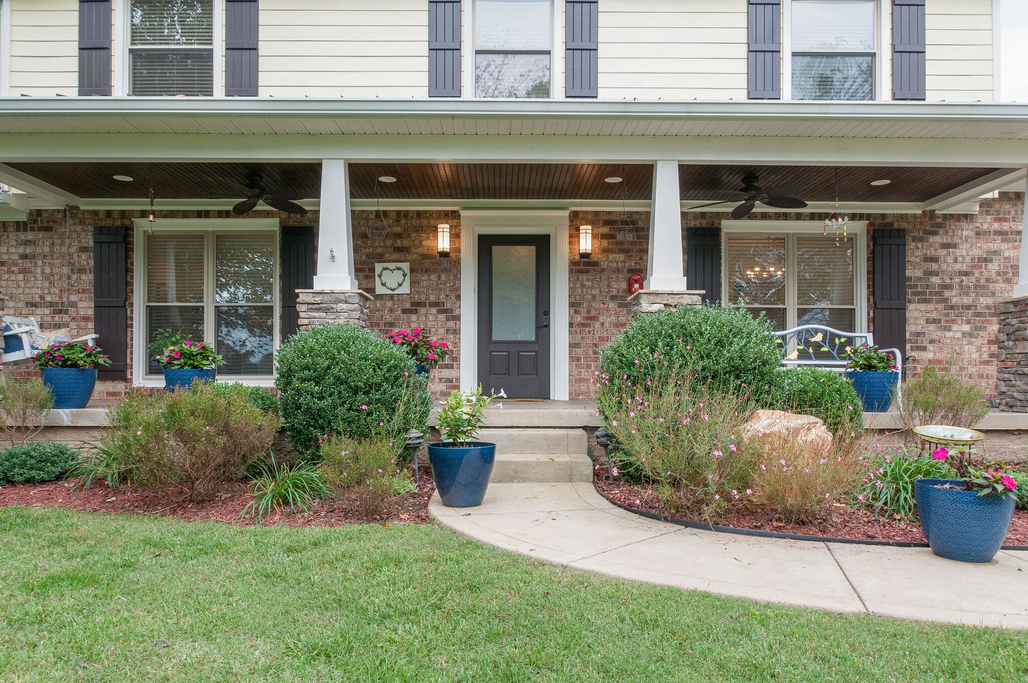 147 Baltusrol Road Franklin, TN 37069 - Photo 5 of 41 front view of a brick house with potted plants