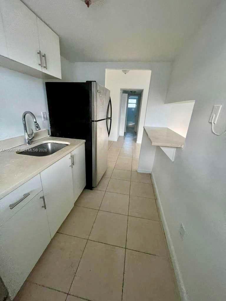 a hallway with a washer and dryer